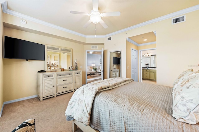 carpeted bedroom featuring crown molding, ceiling fan, and ensuite bath