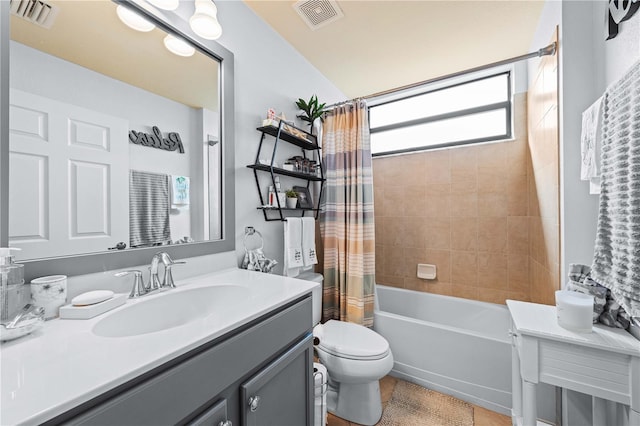 full bathroom with shower / tub combo with curtain, vanity, and toilet