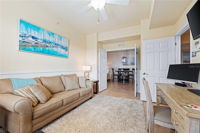 living room featuring tile patterned flooring and ceiling fan