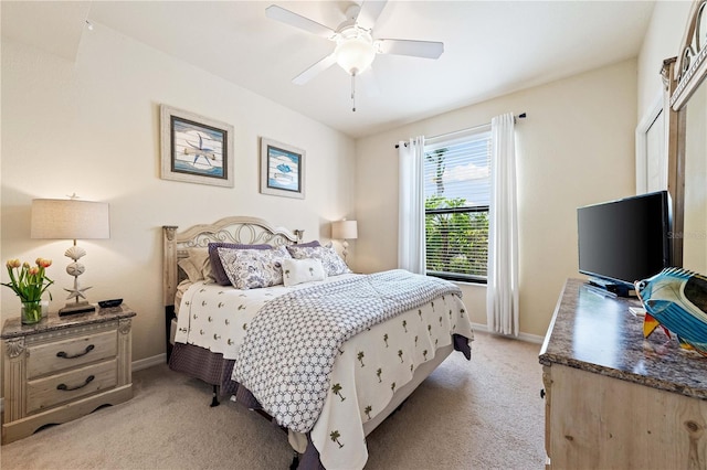 bedroom featuring light colored carpet and ceiling fan