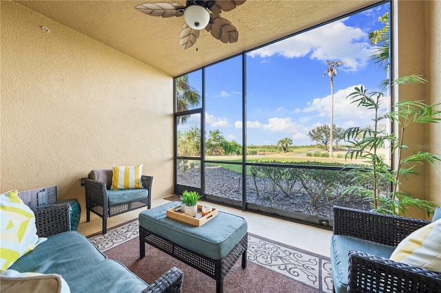 sunroom / solarium featuring ceiling fan