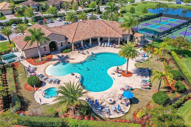 view of swimming pool with a patio and a water view