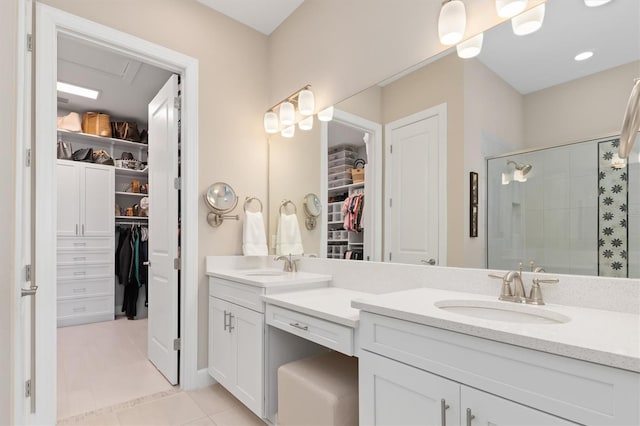 bathroom with walk in shower, vanity, and tile patterned flooring