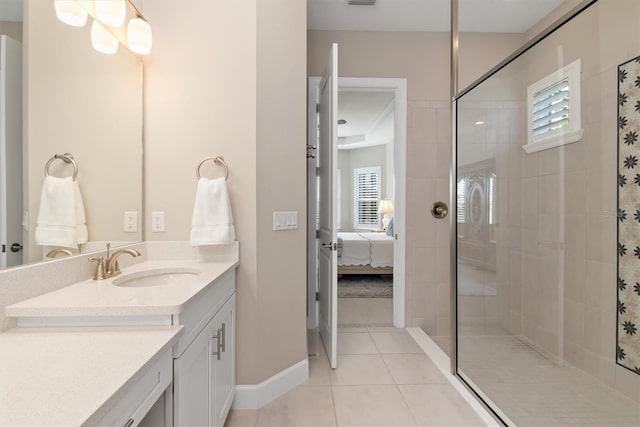 bathroom with vanity, plenty of natural light, tile patterned floors, and a tile shower