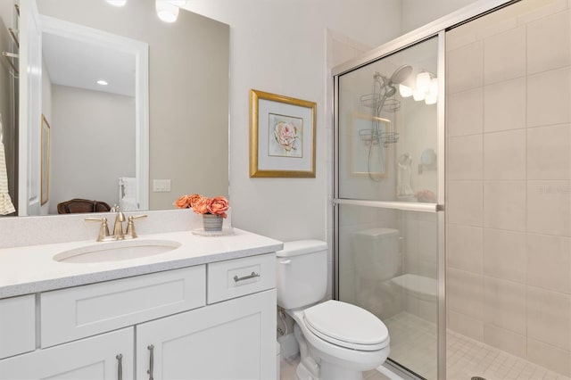 bathroom with walk in shower, vanity, and toilet