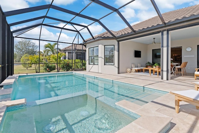 view of pool featuring pool water feature, a patio, ceiling fan, and glass enclosure