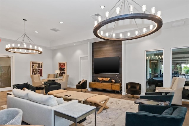 living room featuring an inviting chandelier and light hardwood / wood-style floors