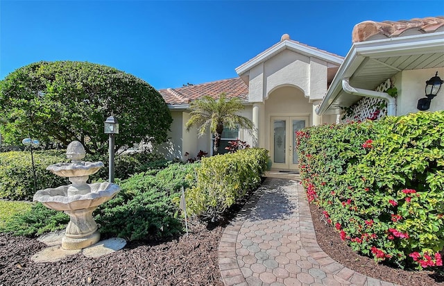 doorway to property with french doors and stucco siding