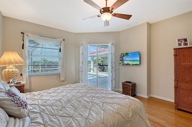 bedroom with baseboards, a ceiling fan, light wood-style flooring, and access to exterior