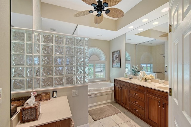 bathroom featuring a garden tub, double vanity, a sink, tile patterned flooring, and walk in shower