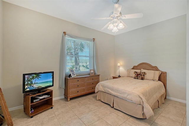 bedroom featuring light tile patterned floors, baseboards, and a ceiling fan