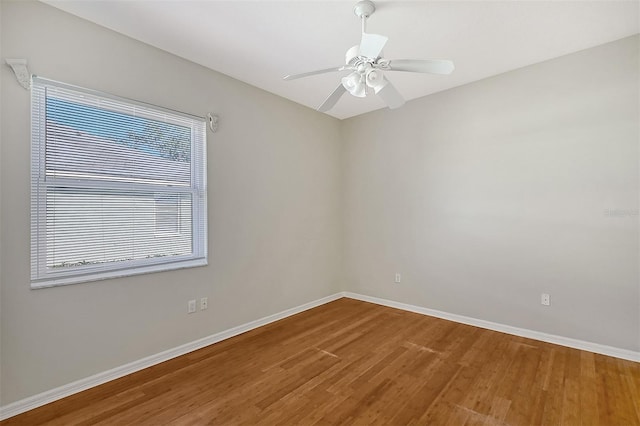 unfurnished room featuring ceiling fan, baseboards, and wood finished floors