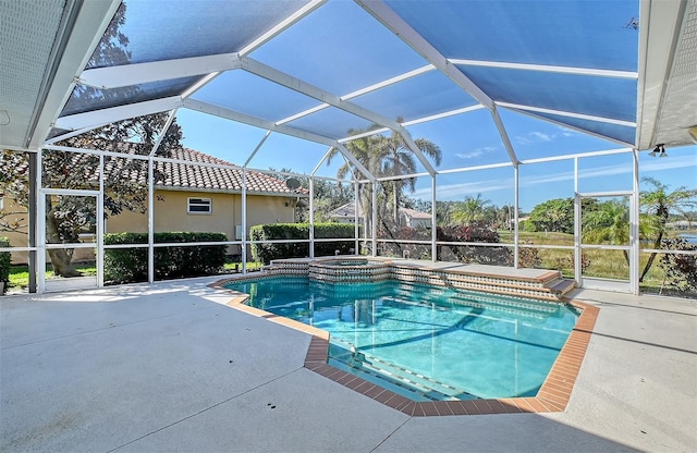 view of swimming pool with a pool with connected hot tub, glass enclosure, and a patio