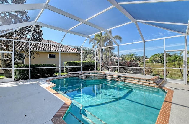 view of swimming pool with a lanai, a pool with connected hot tub, and a patio