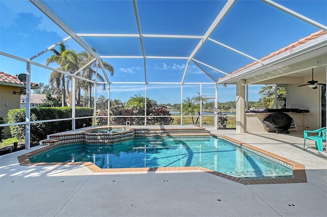 view of swimming pool with a patio, an in ground hot tub, ceiling fan, and glass enclosure