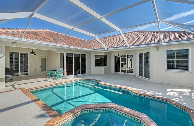 view of pool with ceiling fan, a lanai, and a patio