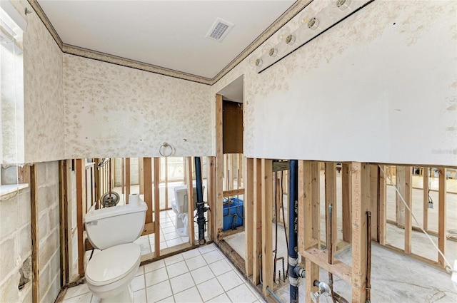 bathroom with toilet, tile patterned flooring, and ornamental molding