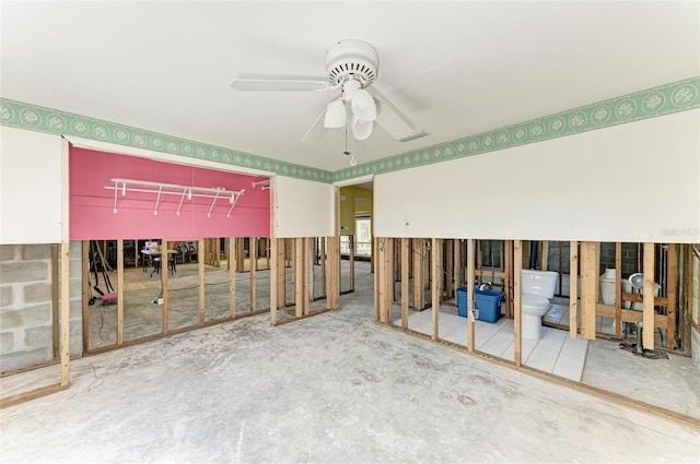 miscellaneous room with ceiling fan and concrete floors