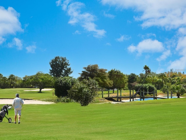 surrounding community with a lawn and a water view