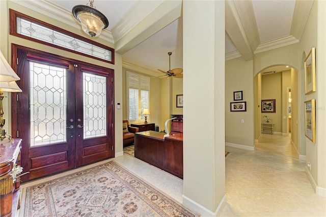 entryway with light tile patterned flooring and ornamental molding