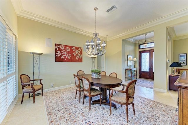 tiled dining space featuring ornamental molding and a notable chandelier