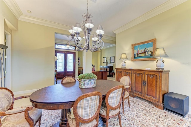 dining area featuring a notable chandelier, crown molding, and french doors