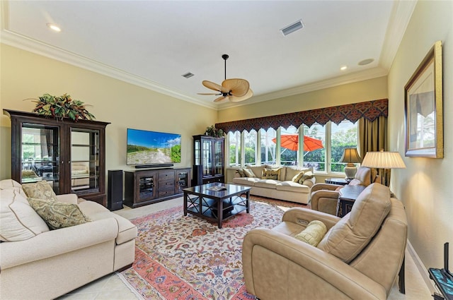 living room with ornamental molding, light tile patterned flooring, and ceiling fan