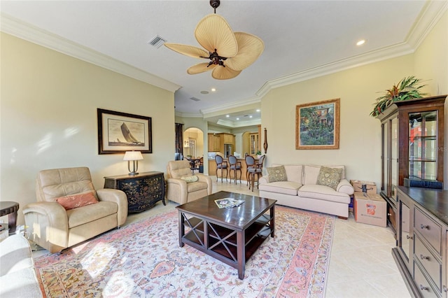 tiled living room featuring ornamental molding and ceiling fan