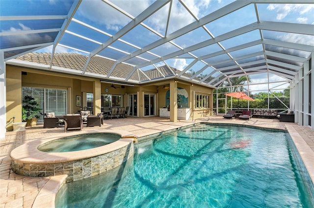 view of pool featuring ceiling fan, a patio, glass enclosure, an outdoor hangout area, and an in ground hot tub