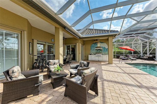 view of patio / terrace featuring ceiling fan, an outdoor living space, a lanai, and area for grilling