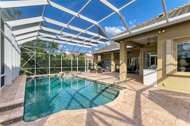 view of pool featuring an in ground hot tub, ceiling fan, a lanai, and a patio area