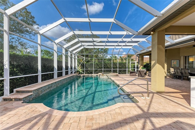 view of pool featuring an in ground hot tub, a patio, and glass enclosure