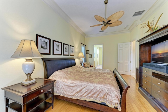 bedroom featuring ceiling fan, ornamental molding, and light wood-type flooring