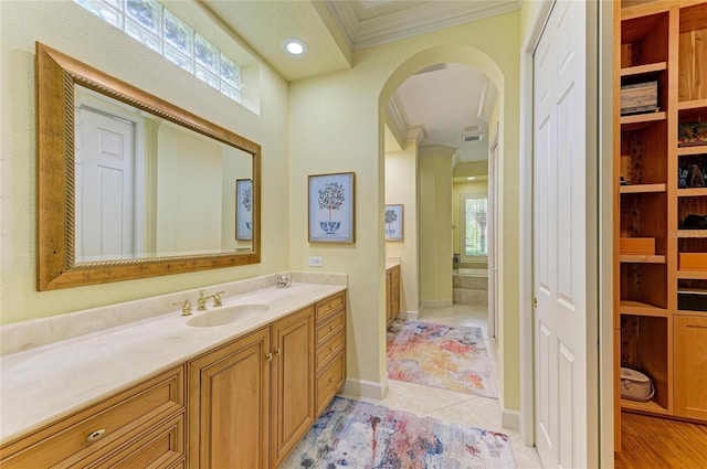 bathroom featuring crown molding, vanity, and tile patterned floors