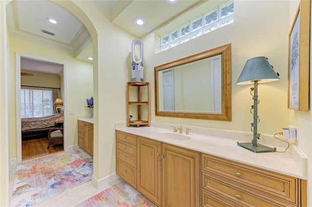 bathroom with tile patterned flooring, crown molding, and vanity