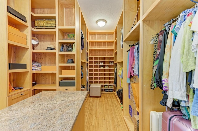 interior space featuring a textured ceiling and light hardwood / wood-style floors