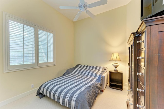 bedroom featuring ceiling fan and light carpet