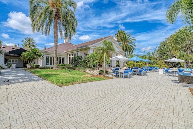 view of front of home with a patio area and a front lawn