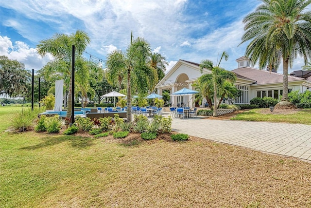 view of community featuring a yard and a patio area