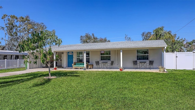 ranch-style home with covered porch and a front yard