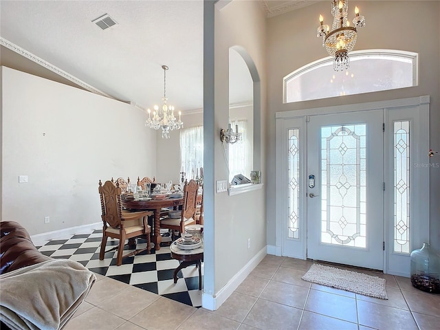 foyer entrance featuring a chandelier and high vaulted ceiling