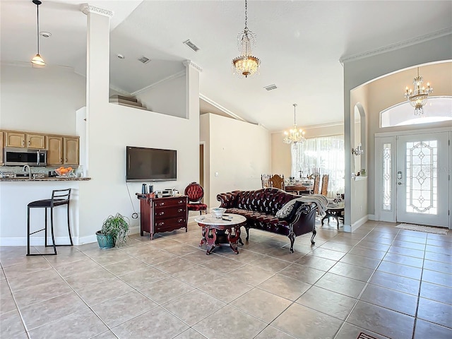 tiled living room with crown molding, high vaulted ceiling, and an inviting chandelier