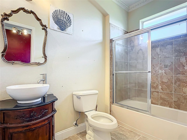 full bathroom featuring toilet, vanity, shower / bath combination with glass door, and tile patterned flooring