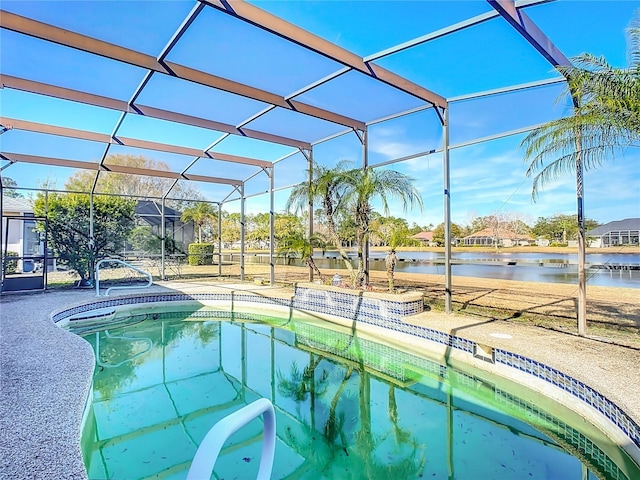 view of swimming pool featuring a water view, a lanai, and a patio area