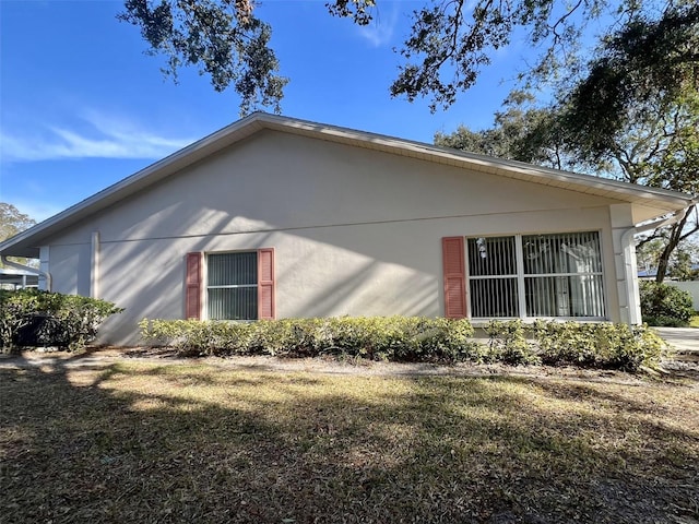 view of side of home featuring a yard