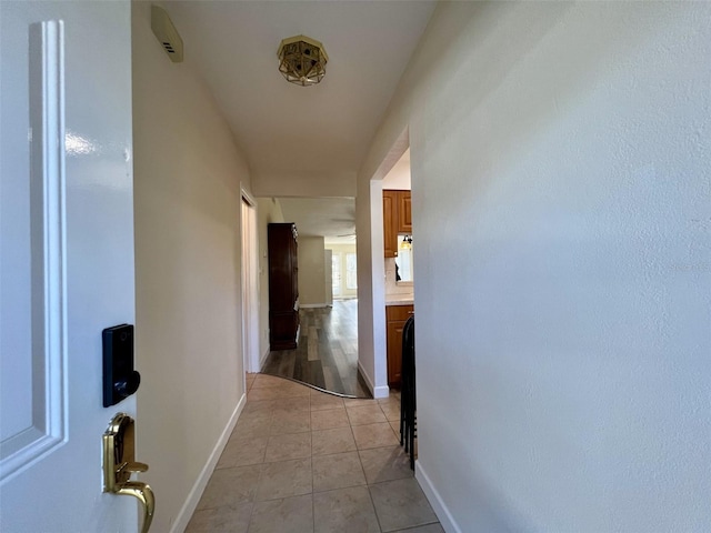 corridor with light tile patterned floors