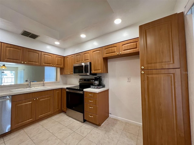 kitchen featuring appliances with stainless steel finishes, sink, and decorative backsplash