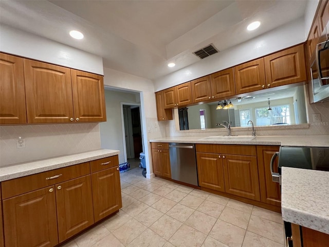 kitchen with stainless steel appliances, sink, and backsplash