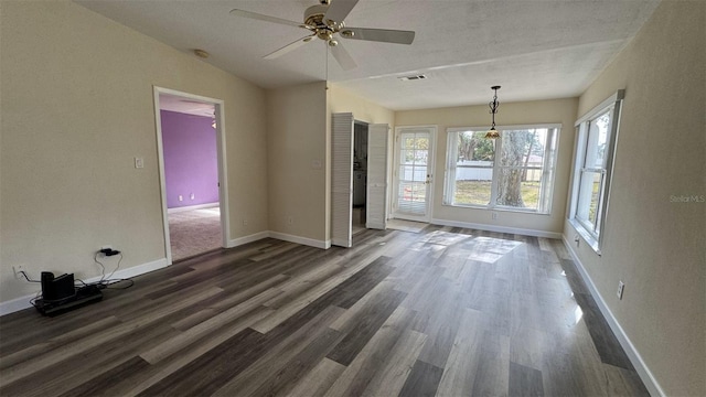 empty room with dark wood-type flooring, ceiling fan, and vaulted ceiling