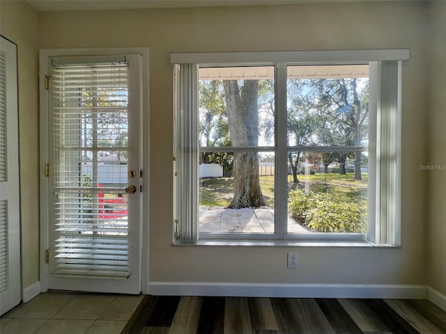 doorway to outside featuring tile patterned floors